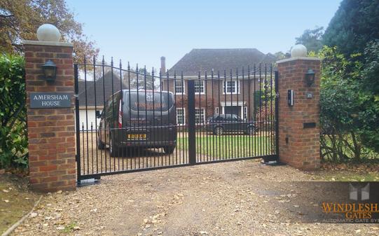 Inverted Metal Gates with Brick Piers and Lighting